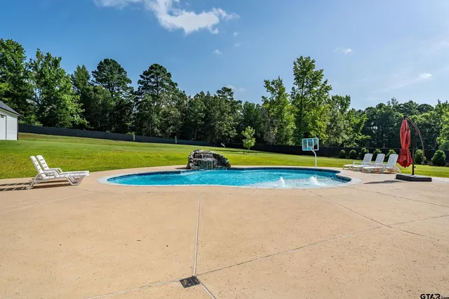 a view of a swimming pool and trees in the background