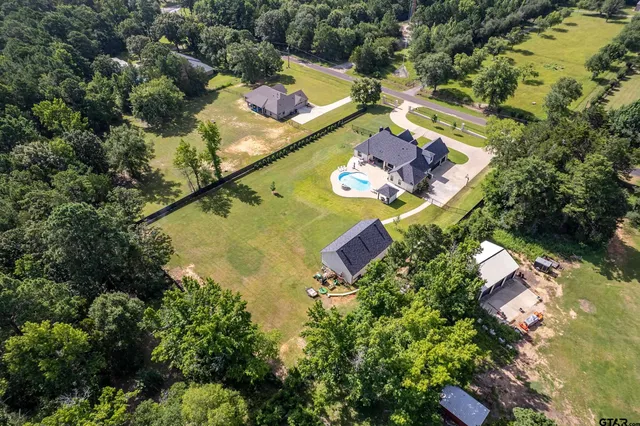 an aerial view of a house with a yard