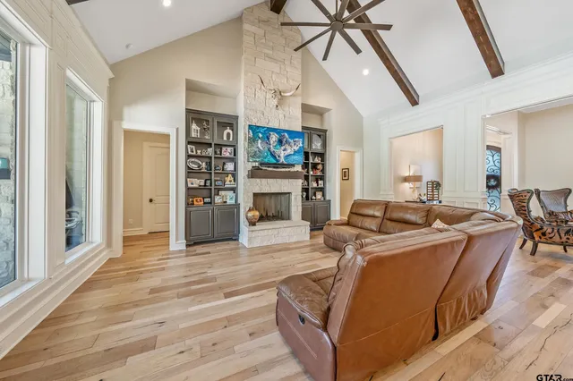 a living room with furniture a fireplace and a flat screen tv