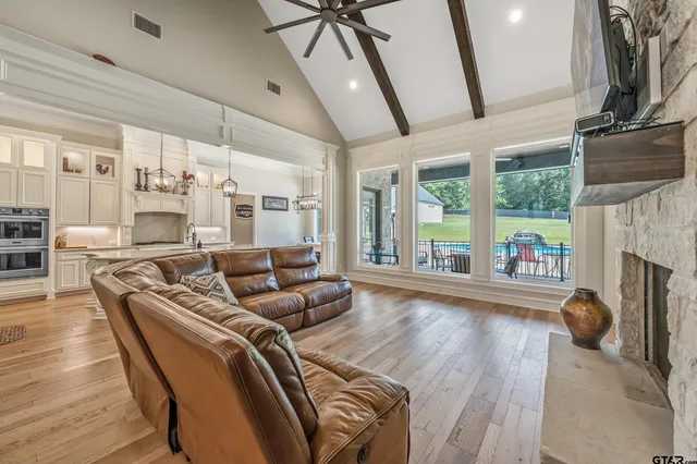 a living room with furniture fireplace and flat screen tv