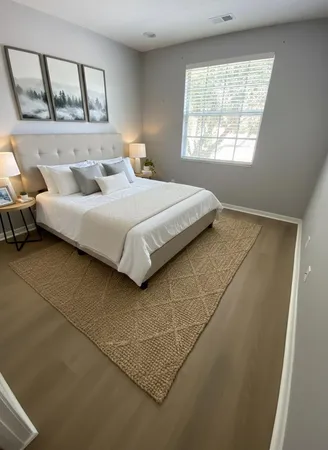 a bedroom with a bed and a large window