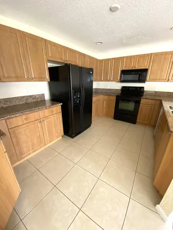 a kitchen with stainless steel appliances a refrigerator sink and cabinets