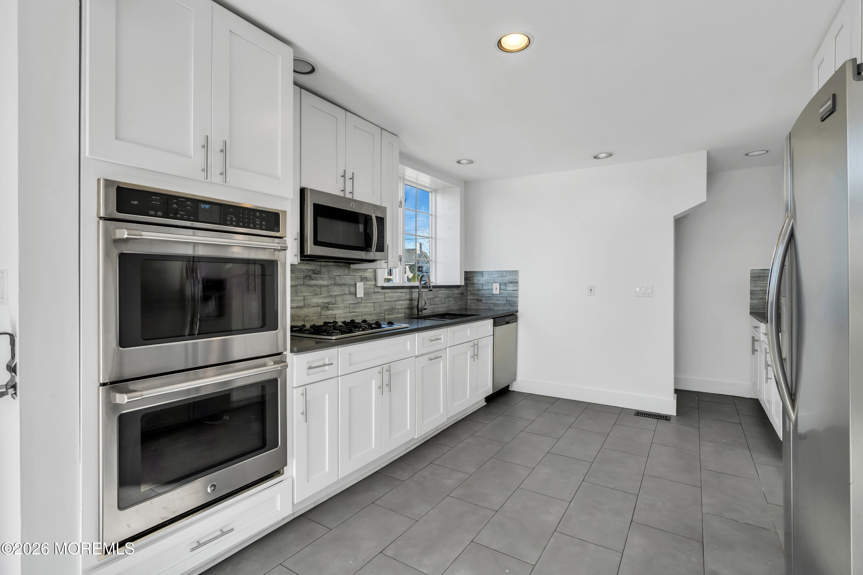 3 Royal Place Long Branch, NJ 07740 - Photo 11 of 23 a kitchen with granite countertop white cabinets stainless steel appliances and a sink