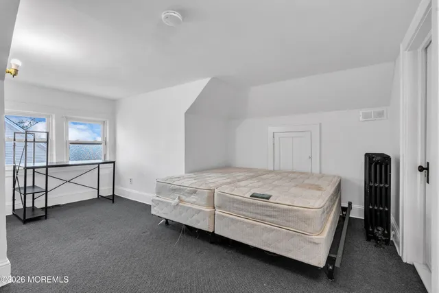 a bed room with a bed and a window