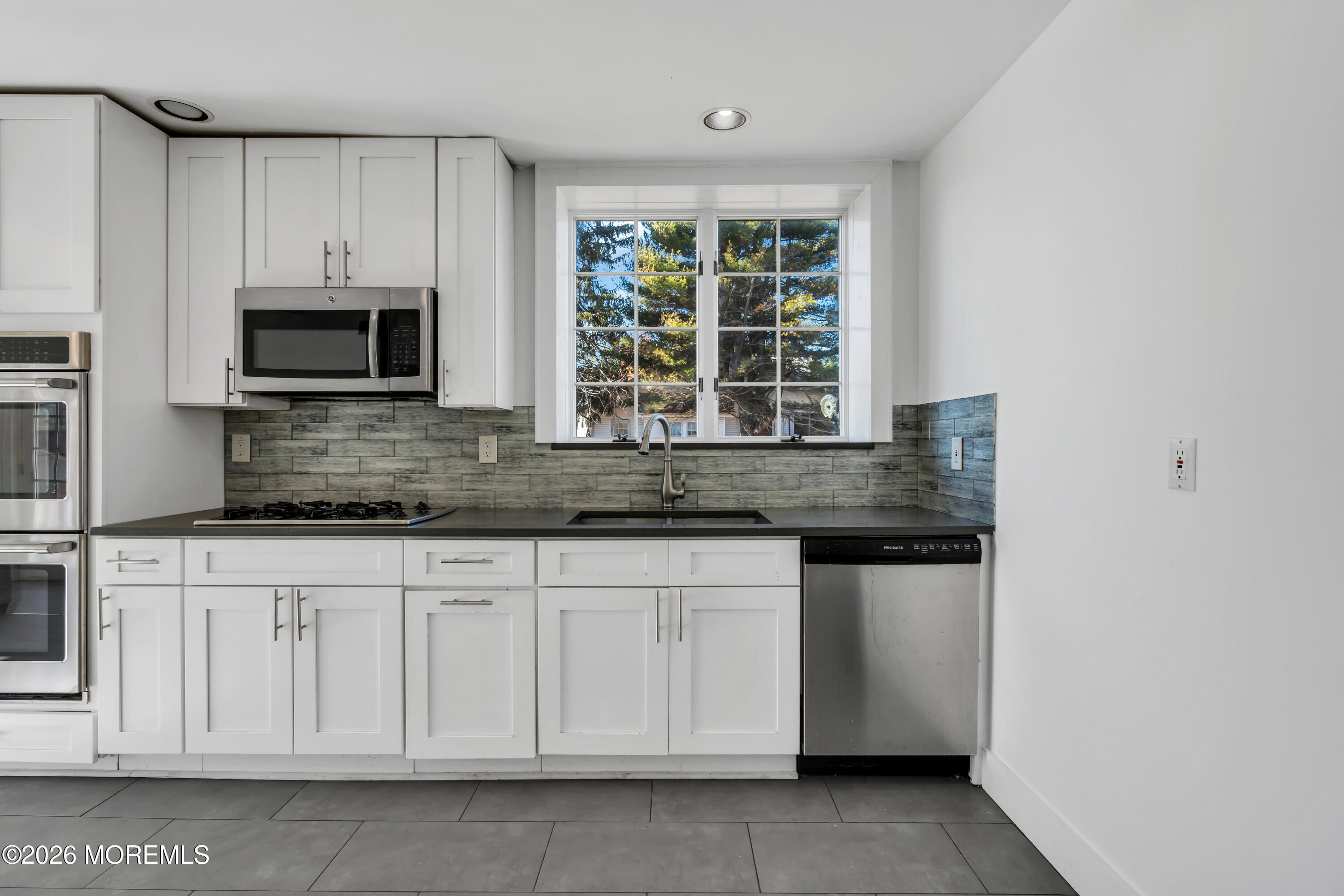 3 Royal Place Long Branch, NJ 07740 - Photo 8 of 23 a kitchen with granite countertop white cabinets and stainless steel appliances