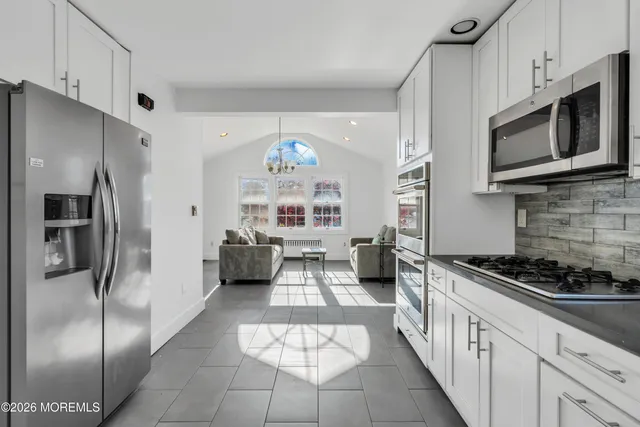 a kitchen with stainless steel appliances a refrigerator a stove a microwave and cabinets