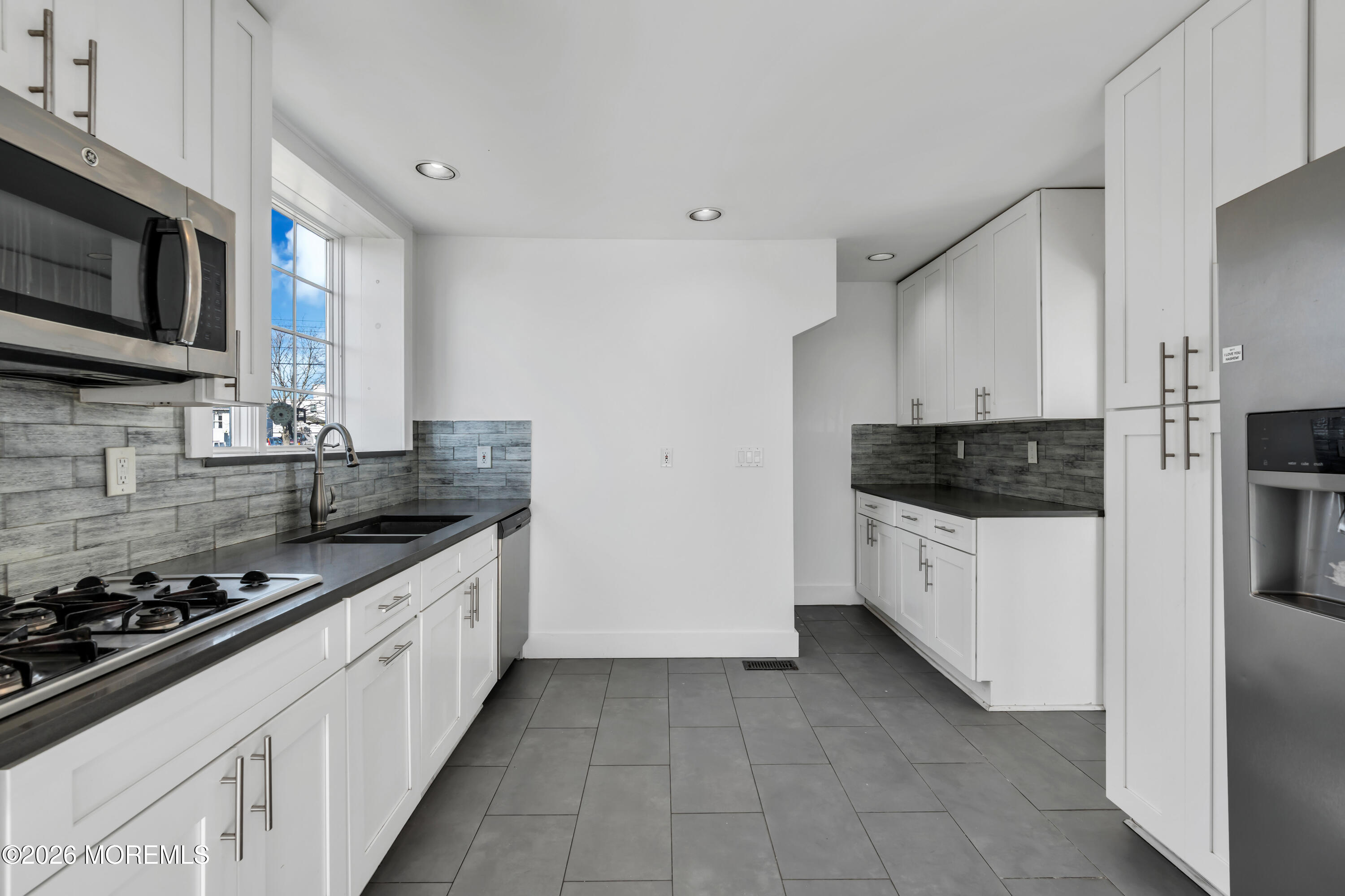3 Royal Place Long Branch, NJ 07740 - Photo 10 of 23 a kitchen with stainless steel appliances a stove a microwave a sink a refrigerator and white cabinets