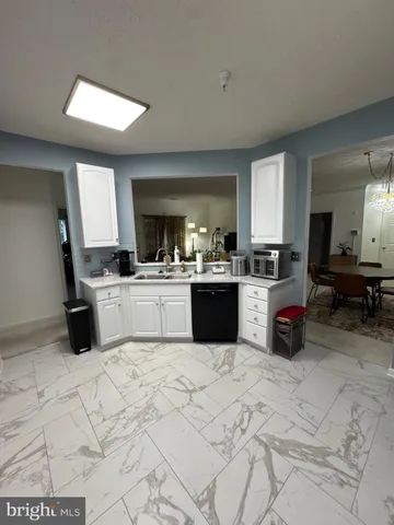a kitchen with a sink a stove and cabinets