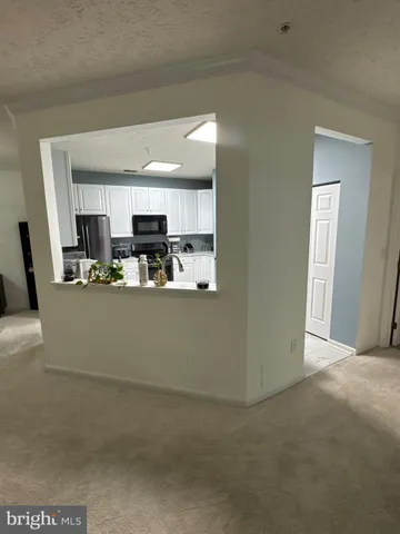 a view of kitchen with microwave and cabinets