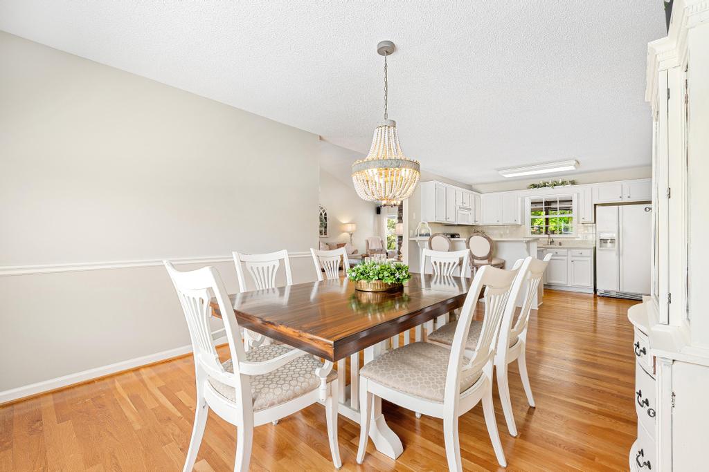848 Perkins Creek Road Seneca, SC 29678 - Photo 11 of 26 This dining area with hardwood floors and a unique chandelier flows into a bright kitchen.