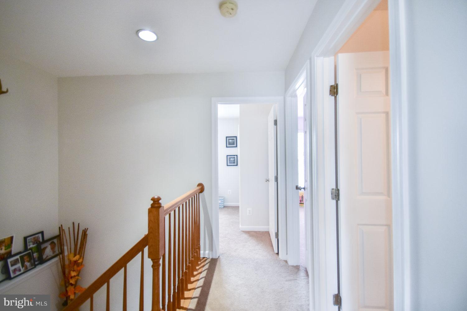 1240 Steed Street Ranson, WV 25438 - Photo 17 of 30 a view of a hallway with wooden floor and staircase