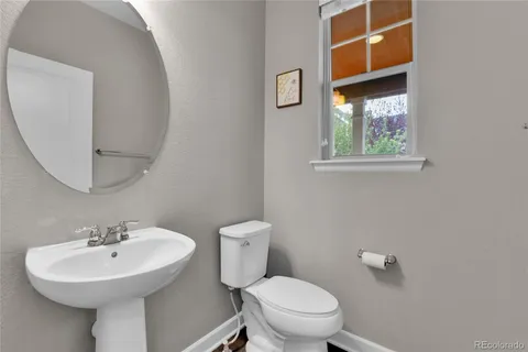 a bathroom with a sink a mirror and a toilet