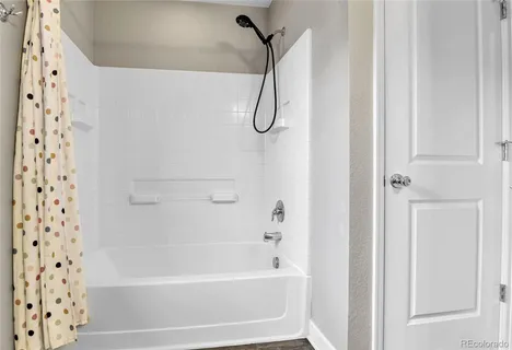 a bathroom with a bath tub with a shower