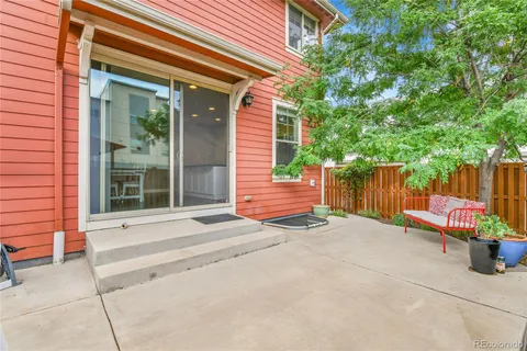 a backyard of a house with chairs and a barbeque