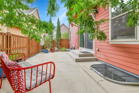 a backyard of a house with outdoor seating