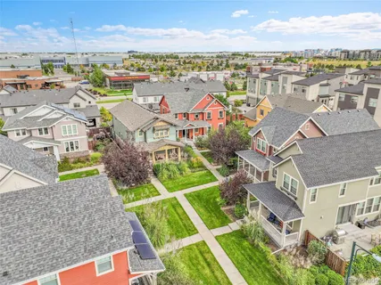 an aerial view of residential houses with outdoor space and ocean view