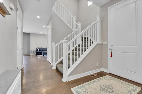 a view of entryway and hall with wooden floor
