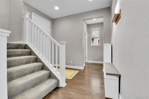 a view of entryway and hall with wooden floor
