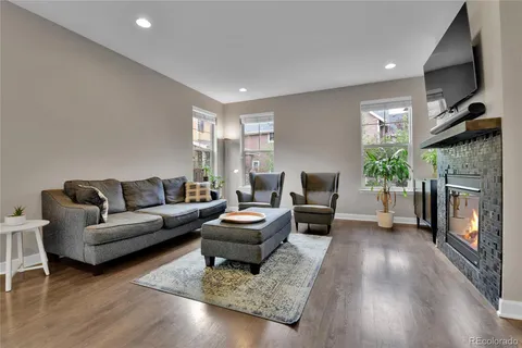 a living room with furniture flat screen tv and a fireplace