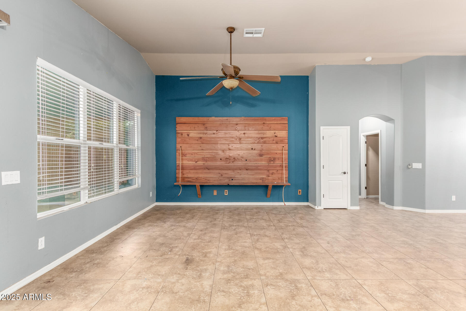 20768 West Hamilton Street Buckeye, AZ 85396 - Photo 12 of 33 a view of an empty room with window and chandelier fan