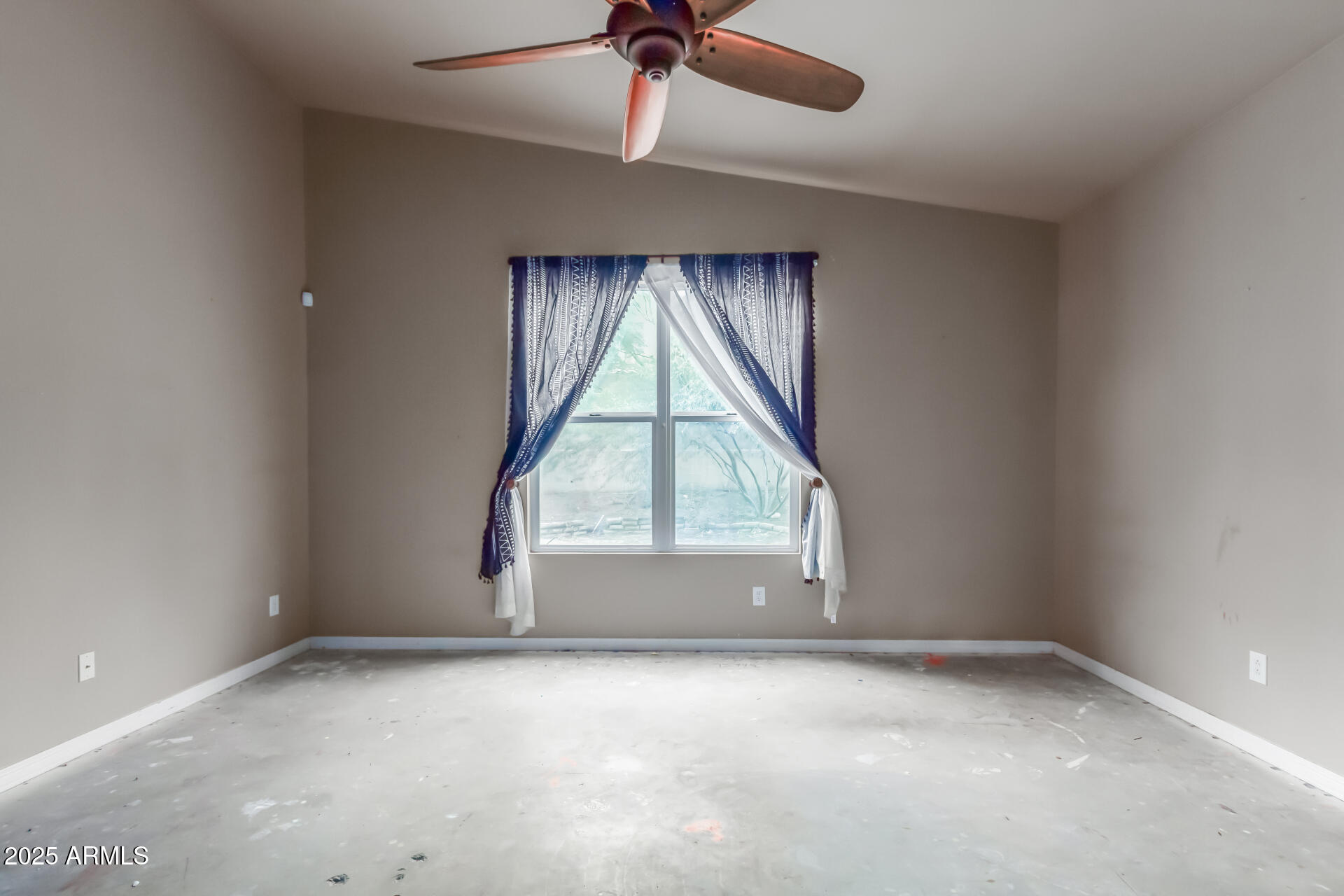 20768 West Hamilton Street Buckeye, AZ 85396 - Photo 15 of 33 an empty room with a window and ceiling fan