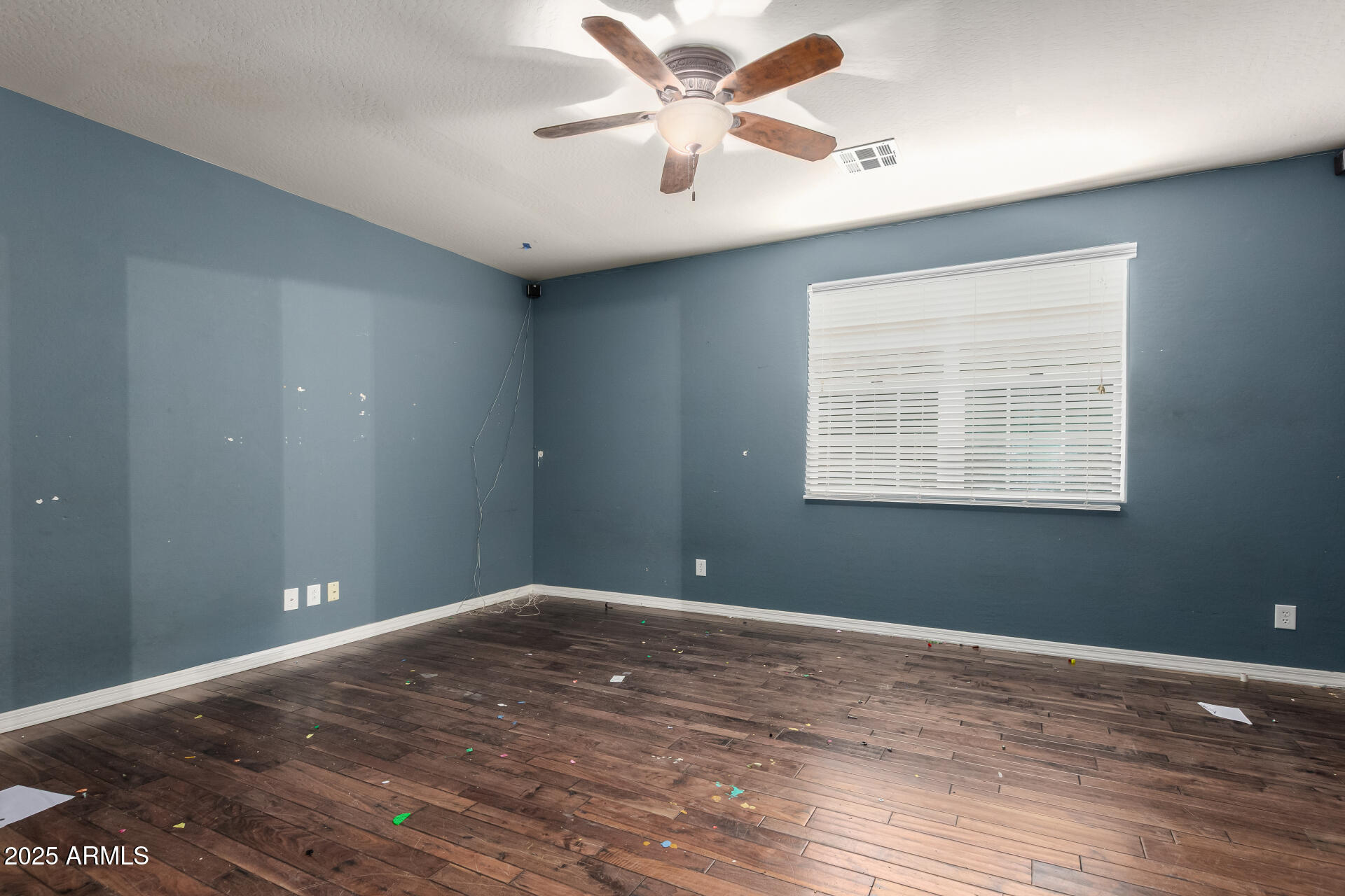 20768 West Hamilton Street Buckeye, AZ 85396 - Photo 19 of 33 a view of an empty room with window and wooden floor
