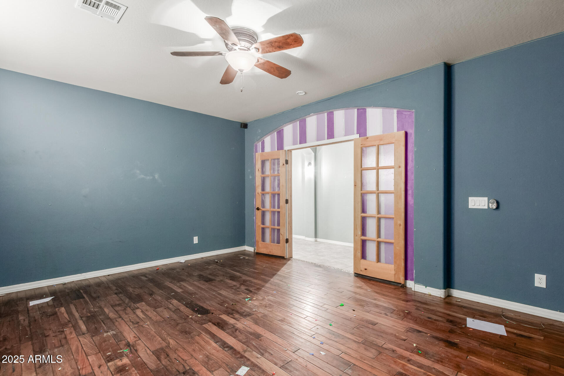 20768 West Hamilton Street Buckeye, AZ 85396 - Photo 20 of 33 an empty room with wooden floor and windows