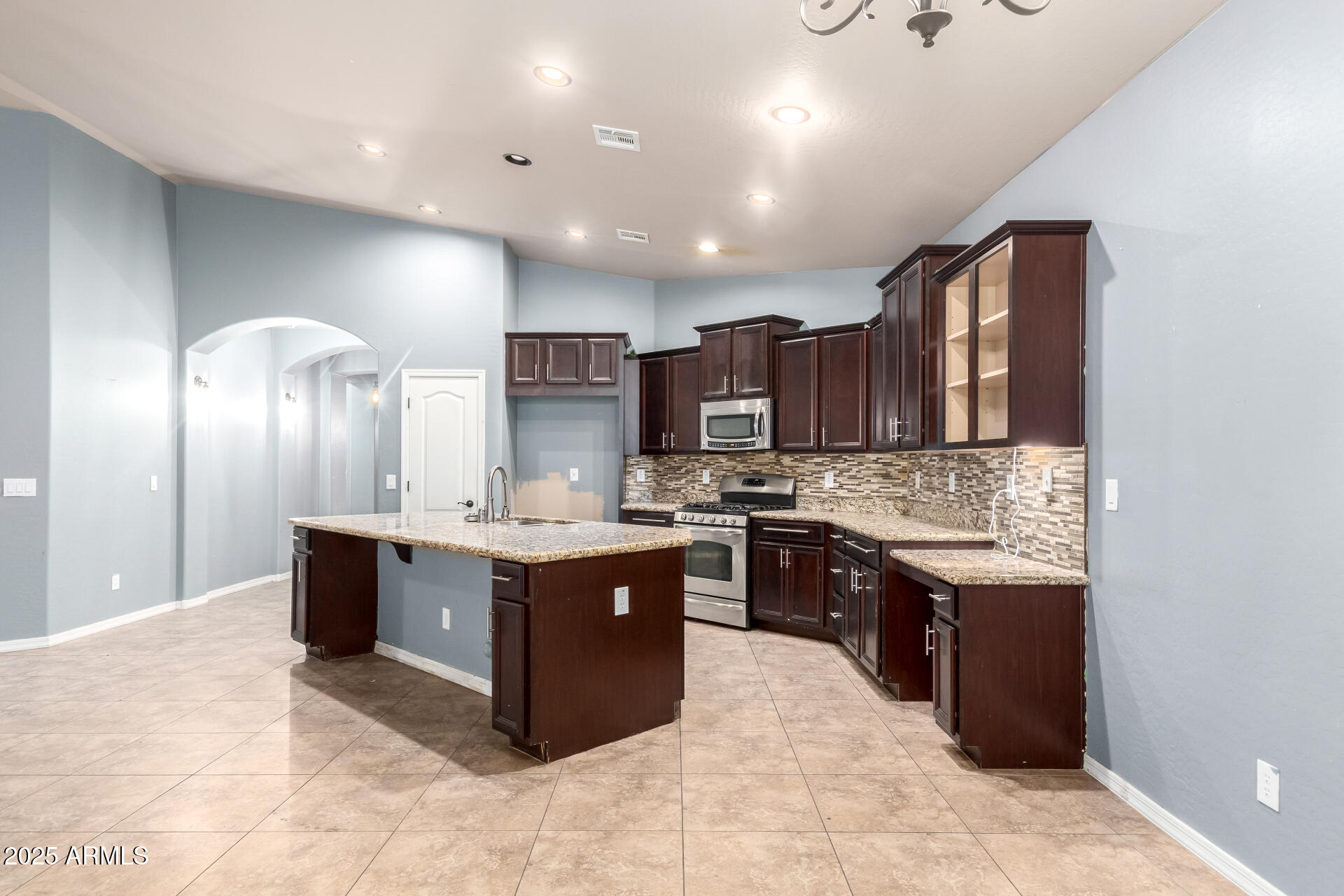 20768 West Hamilton Street Buckeye, AZ 85396 - Photo 10 of 33 a large kitchen with a stove and cabinets