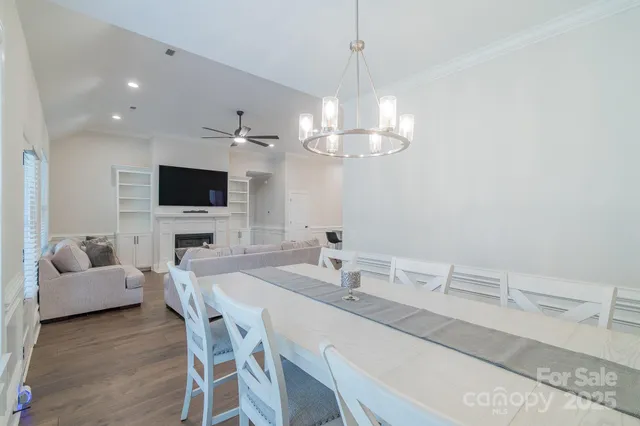 a view of a dining room with furniture and a flat screen tv