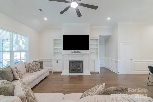 a living room with fireplace furniture and a flat screen tv