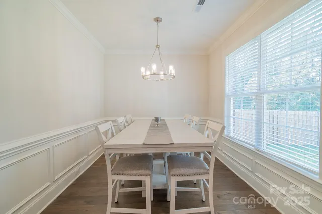 a view of a dining room with furniture and window
