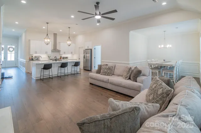 a living room with furniture and kitchen view