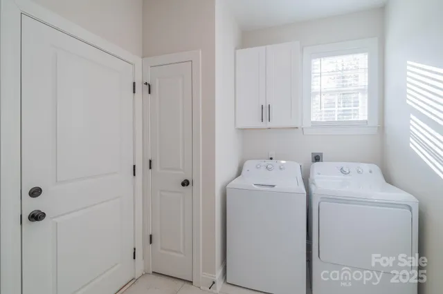 a view of bathroom with a washer and dryer