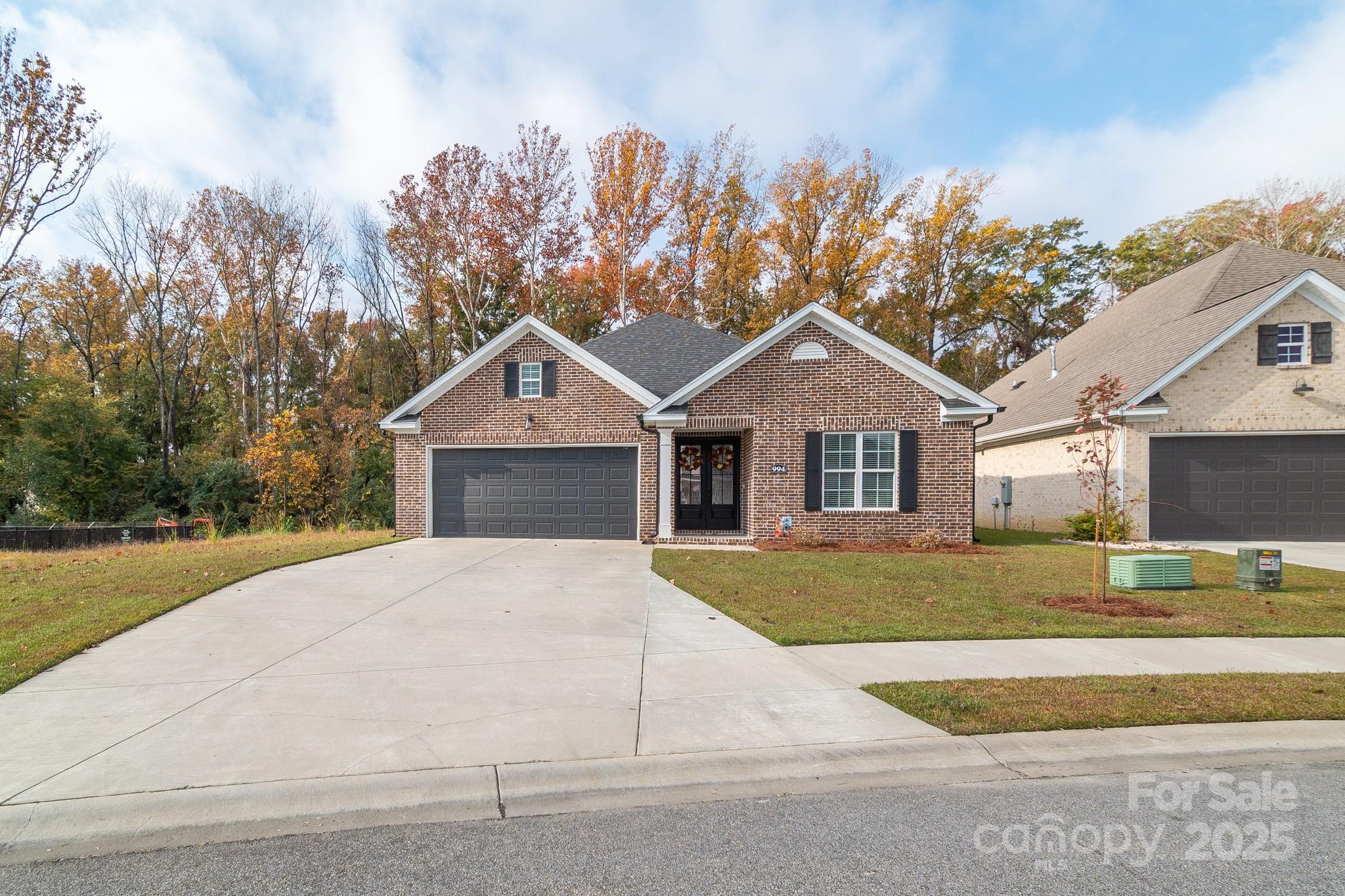 994 Cedar Crest Lane Florence, SC 29501 - Photo 2 of 42 a front view of a house with a yard and garage