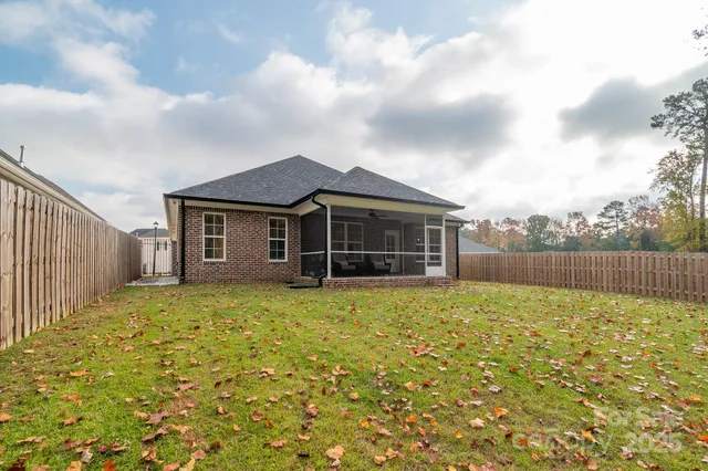 an aerial view of a house with yard swimming pool and outdoor seating