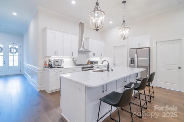 a kitchen with a dining table a sink and cabinets