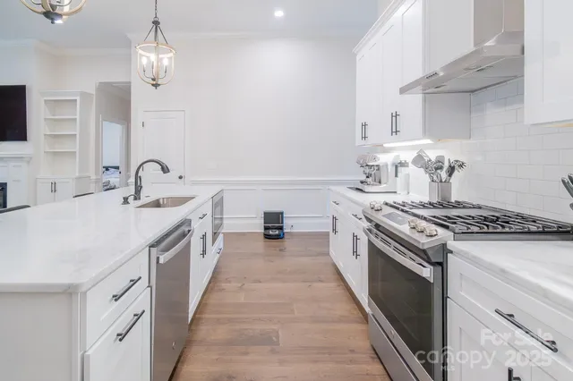 a large kitchen with a stove and a sink