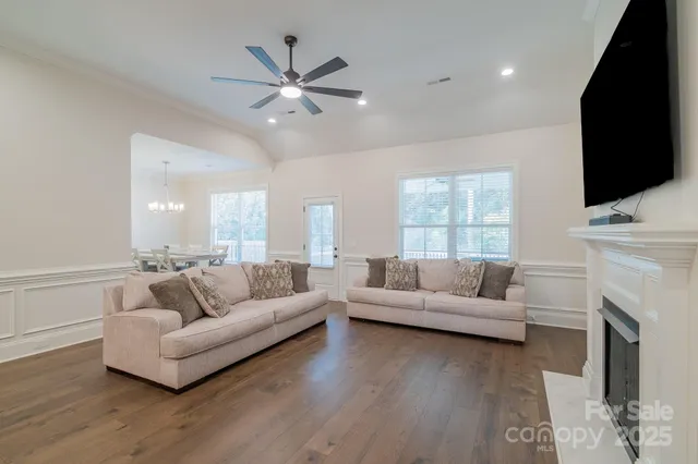 a living room with fireplace furniture and a flat screen tv