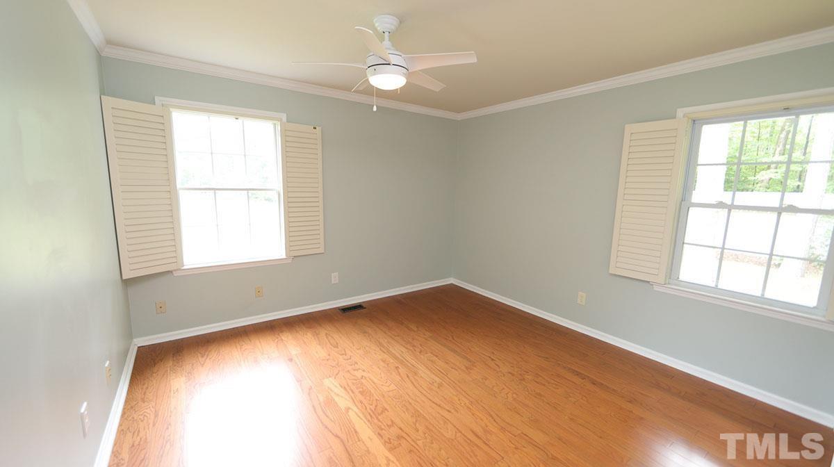 3421 Coley Road Durham, NC 27703 - Photo 16 of 30 Engineered hardwoods have been added to the master bedroom and hallway. There is a fan in the master with two windows with shutters.