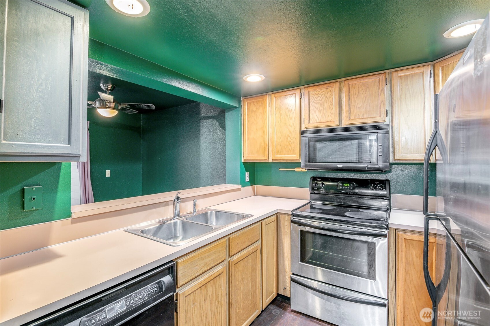 110 Southwest 116th Street, Unit A13 Seattle, WA 98146 - Photo 7 of 16 a kitchen with a sink stove and cabinets
