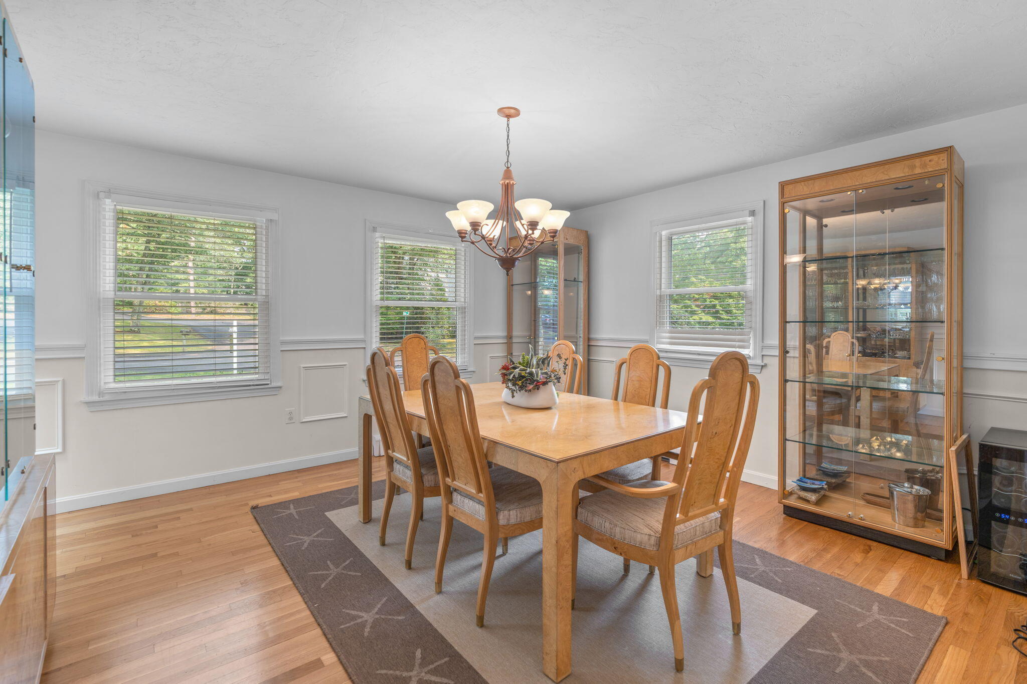 104 Pond Circle Mashpee, MA 02649 - Photo 14 of 29 a dining room with furniture a chandelier and wooden floor