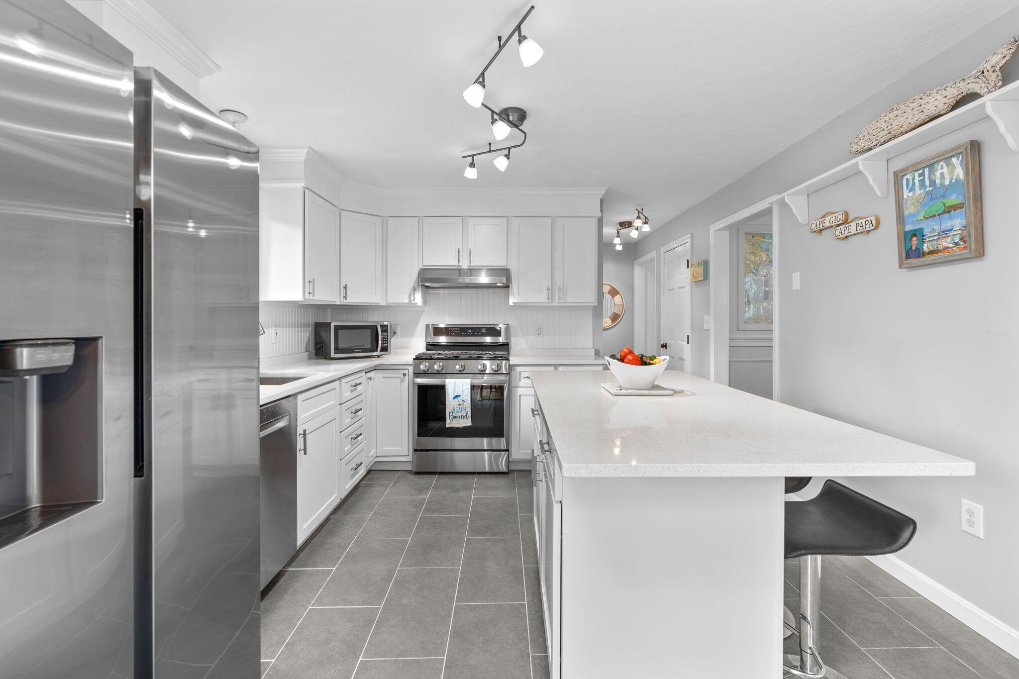 104 Pond Circle Mashpee, MA 02649 - Photo 18 of 29 a large white kitchen with cabinets a sink and appliances