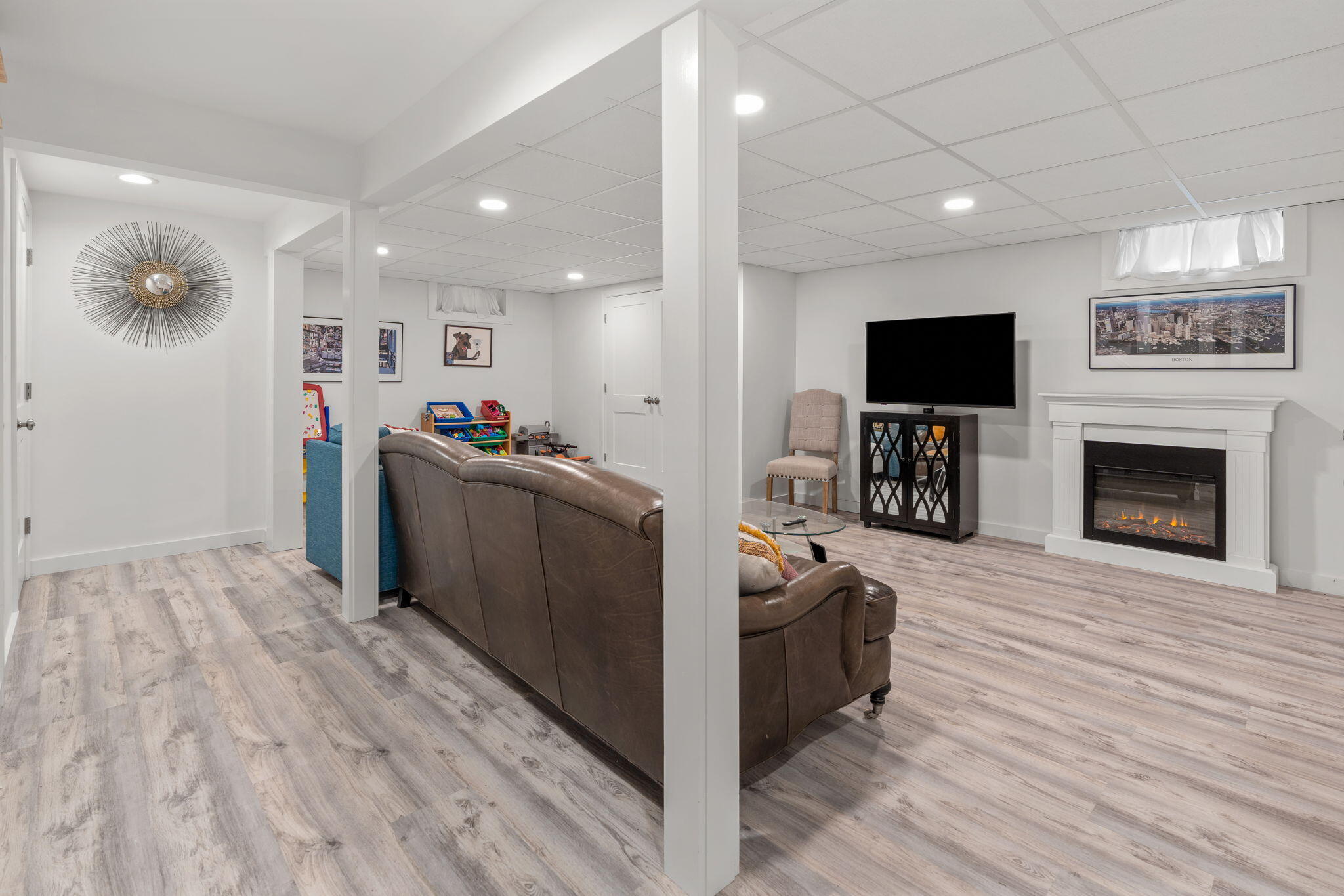 104 Pond Circle Mashpee, MA 02649 - Photo 25 of 29 a living room with furniture a flat screen tv and a fireplace