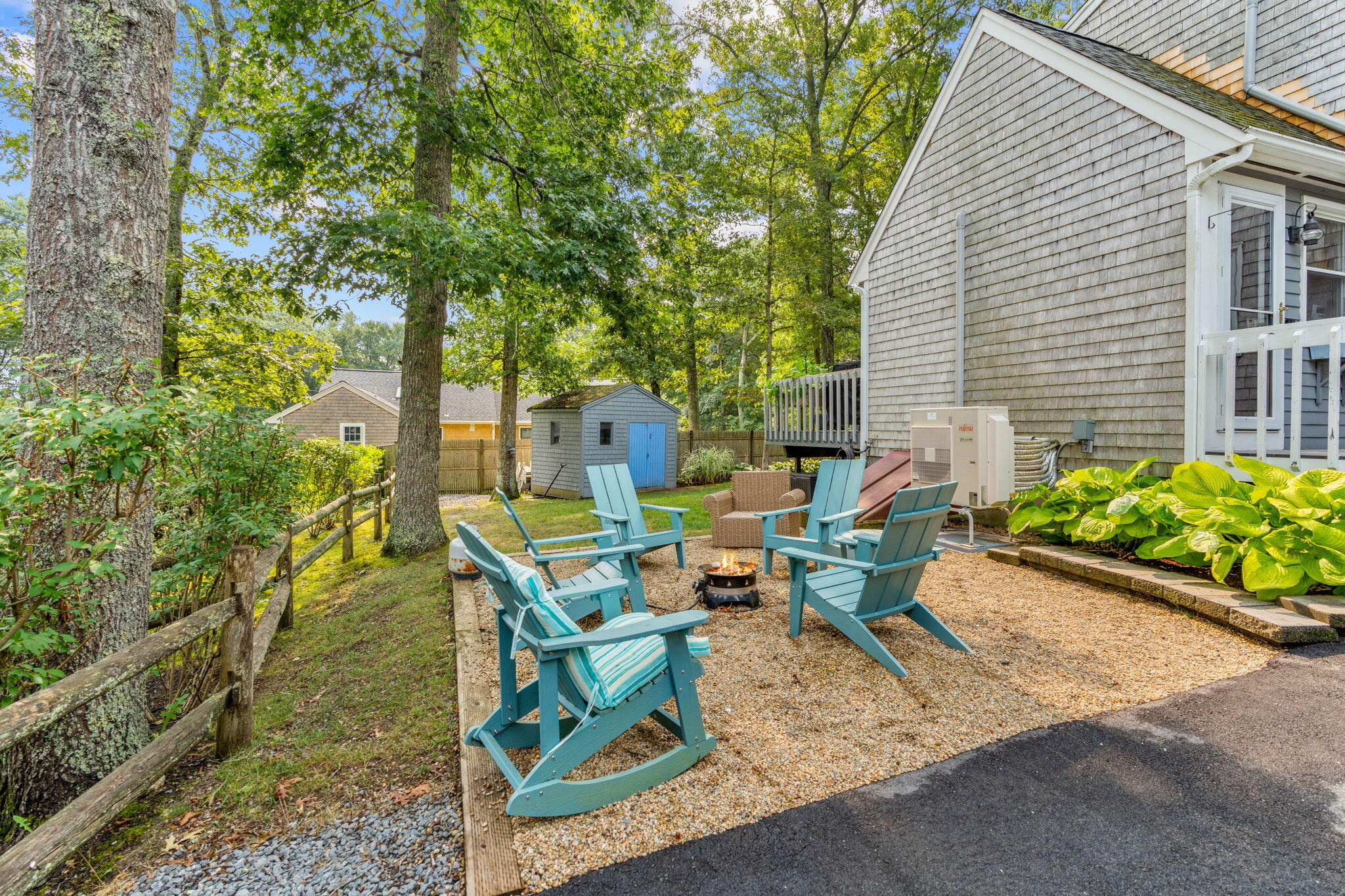 104 Pond Circle Mashpee, MA 02649 - Photo 5 of 29 a view of a patio with table and chairs and potted plants