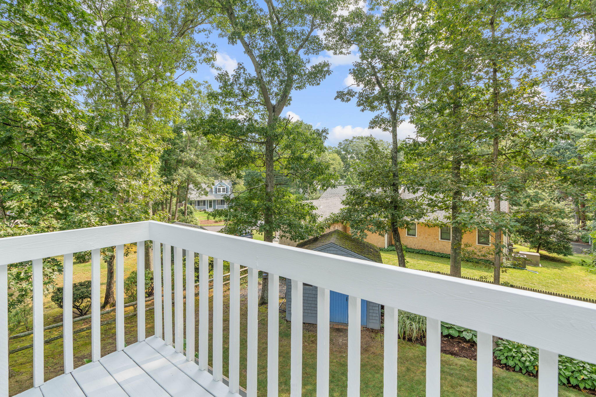 104 Pond Circle Mashpee, MA 02649 - Photo 6 of 29 a balcony with trees in front of it
