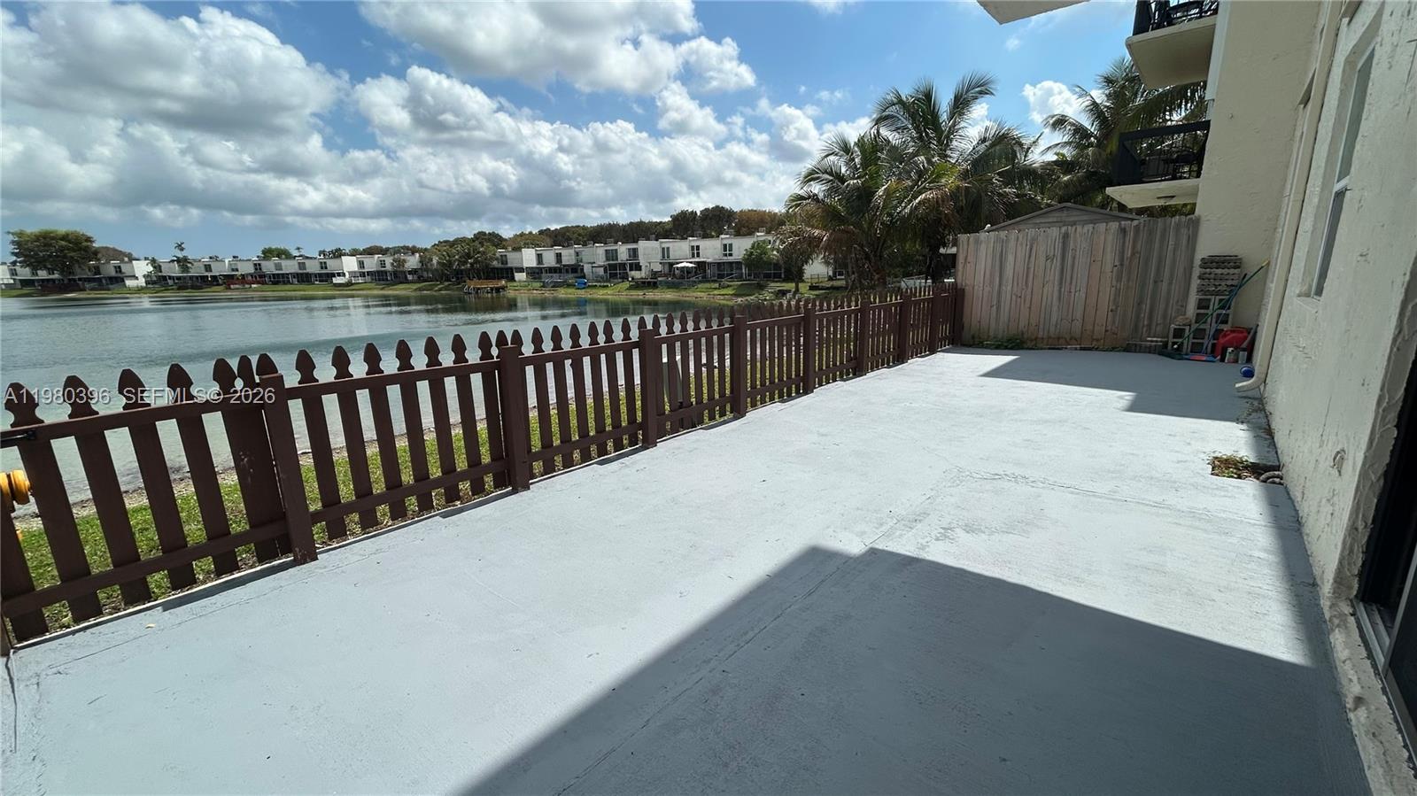 8307 Southwest 142nd Avenue, Unit E112 Miami, FL 33183 - Photo 10 of 12 a balcony with wooden floor