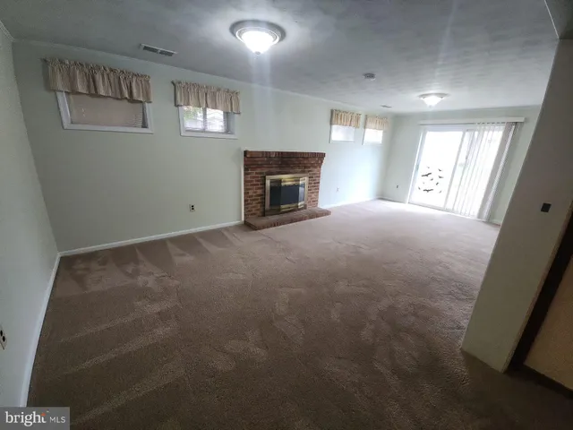 a view of empty room with a fireplace