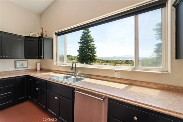 a kitchen with a sink and a large window