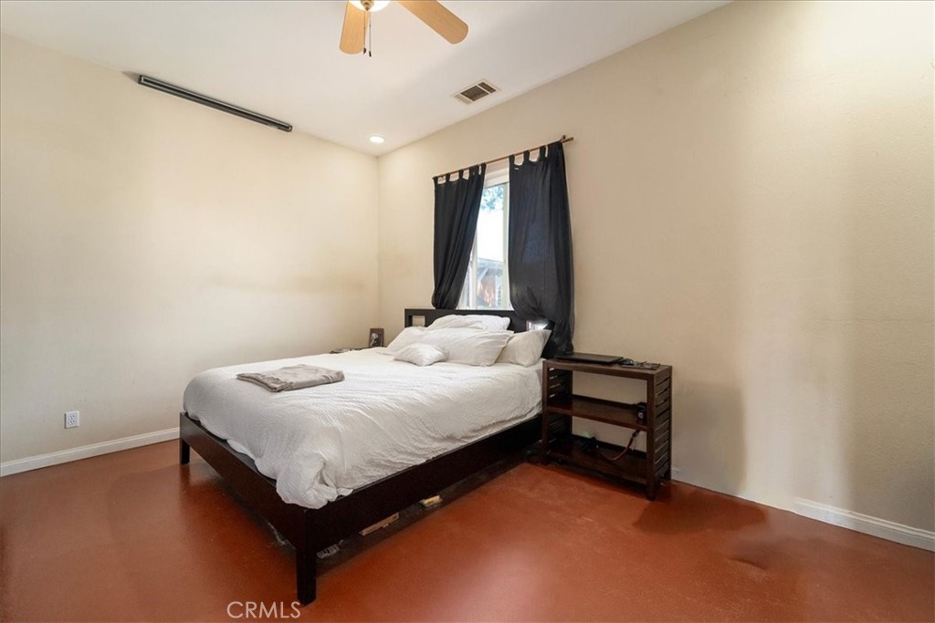 39875 Bautista Road Anza, CA 92539 - Photo 22 of 44 a bedroom with a bed and a wall painting