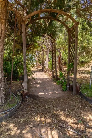 a view of a yard with wooden fence